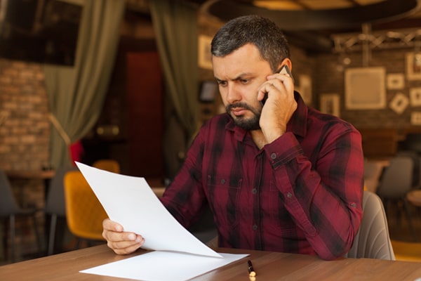 Man Reading IRS Letter