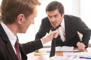 Boss Pulling tie of angry employee